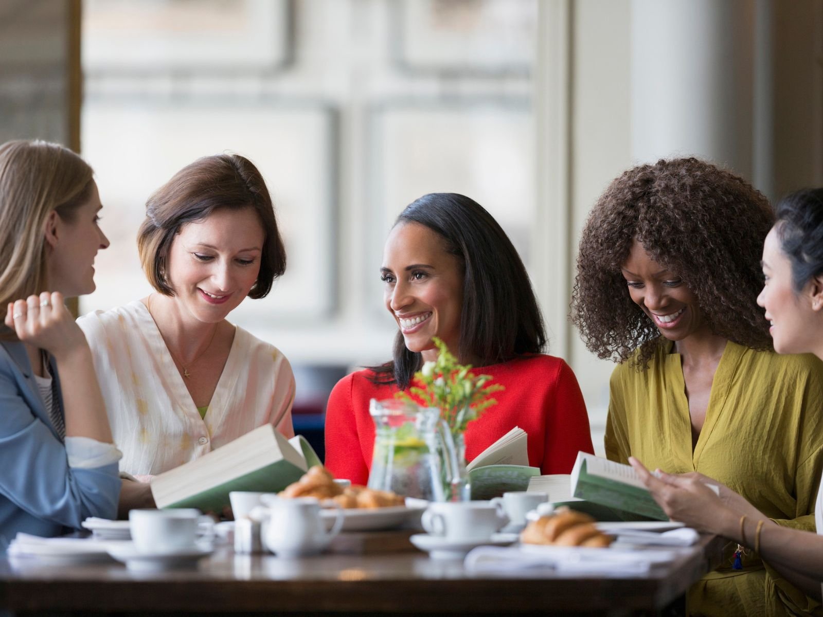 A small group of women in conversation around a café table